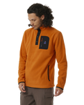 The Rip Curl Mens Anti-Series Search Polar Fleece in Orange Amber