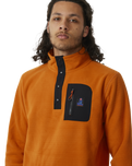 The Rip Curl Mens Anti-Series Search Polar Fleece in Orange Amber