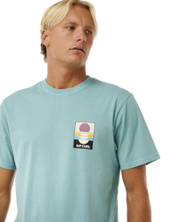 The Rip Curl Mens Surf Revival Peaking T-Shirt in Dusty Blue