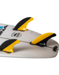 The FCS FCS II Mick Fanning PC Tri Surfboard Fins in Black & Mango